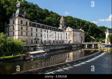 Tourist boat and the Benedictine abbey abbaye Saint-Pierre de Brantôme along the river Dronne, Dordogne, Aquitaine, France Stock Photo