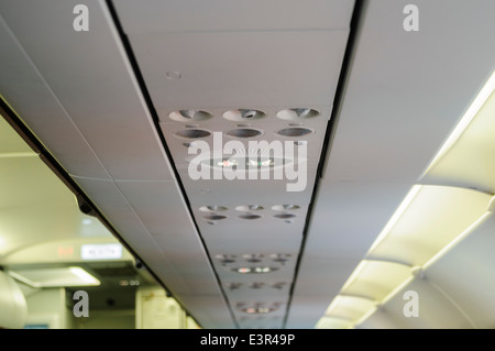 Overhead lights and ventilation on board an Airbus A320 Stock Photo