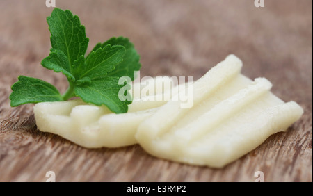 Chewing gum with green stevia on wooden surface Stock Photo