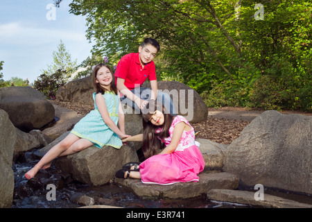 Portrait of siblings enjoying springtime at the park Stock Photo