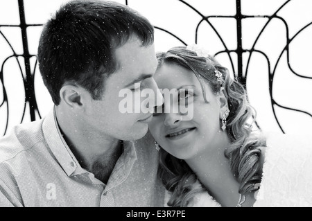 European newlyweds embrace outdoor in the winter. Black and white photo Stock Photo