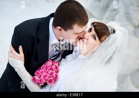 European newlyweds embrace outdoor in the winter Stock Photo