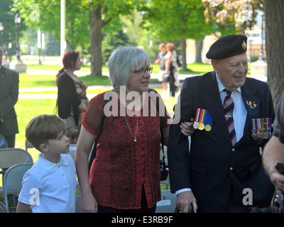 Politicians, members of  the public, veterans and serving military personnel attend a ceremony on the 70th anniversary of D-day. Stock Photo