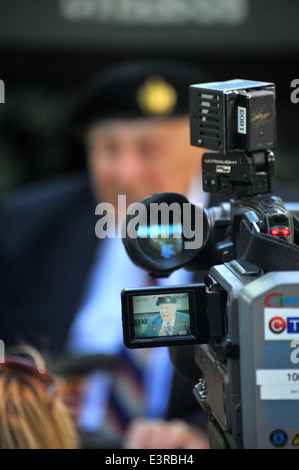 Politicians, members of  the public, veterans and serving military personnel attend a ceremony on the 70th anniversary of D-day. Stock Photo