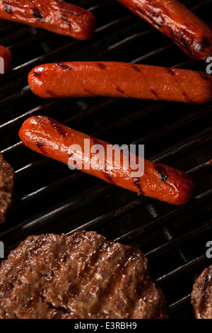 Delicious Hamburgers and Hot Dogs on the Grill Stock Photo