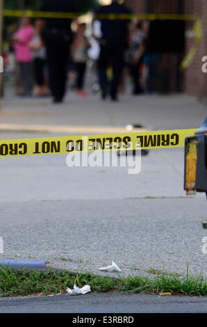 New York, USA. 27th June 2014.  Jun 27 2014 700 East 140 street, New York, USA//Crime scene tape at the Male shot at 700 East 140 street. Police are searching for 3 male blacks, 1 wearing a red shirt and 2 wearing white shirts and blue jeans. Injured male treated and transported by EMS with unknown severity of injuries. Credit:  Michael Glenn/Alamy Live News Stock Photo