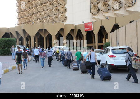 Baghdad, Iraq. 28th June, 2014. Chinese workers arrive at a hotel in Baghdad, Iraq, on June 28, 2014. All of the more than 1,200 Chinese workers trapped in the northern Iraqi city of Samarra have been safely evacuated to the capital Baghdad, according to the Chinese embassy in Baghdad. © Shang Le/Xinhua/Alamy Live News Stock Photo