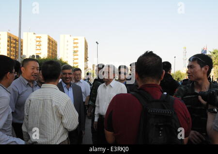 Baghdad, Iraq. 28th June, 2014. Chinese ambassador Wang Yong greets evacuated Chinese workers in Baghdad, Iraq, on June 28, 2014. All of the more than 1,200 Chinese workers trapped in the northern Iraqi city of Samarra have been safely evacuated to the capital Baghdad, according to the Chinese embassy in Baghdad. © Shang Le/Xinhua/Alamy Live News Stock Photo