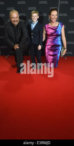 Munich, Germany. 27th June, 2014. The young Canadian actor Kyle Catlett (C), main character of the opening movie 'The Selected Works of T.S. Spivet', the manageress of the festival Diana Iljine and French director Jean-Pierre Jeunet pose during the opening of the Munich film festival in Munich, Germany, 27 June 2014. The festival runs from 27 June to 05 July 2014. Photo: Felix Hoerhager/dpa/Alamy Live News Stock Photo