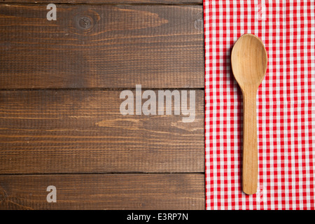 wooden spoon on table with red checked tablecloth Stock Photo