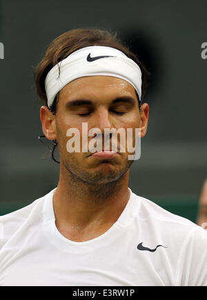 London, London, UK. 28th June, 2014. Rafael Nadal of Spain reacts during the men's singles third round match against Mikhail Kukushkin of Kazakhstan at the 2014 Wimbledon Championships at Wimbledon, southwest London, on June 28, 2014. Credit:  Meng Yongmin/Xinhua/Alamy Live News Stock Photo