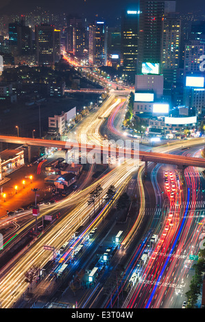 Night traffic blurs past Seoul Station in Seoul, South Korea. Stock Photo