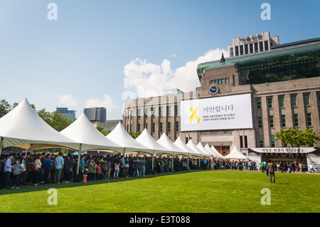 Mourners gather outside of Seoul City Hall on May 6, 2014 to pay their respects to victims of the Sewol ferry tragedy. Stock Photo