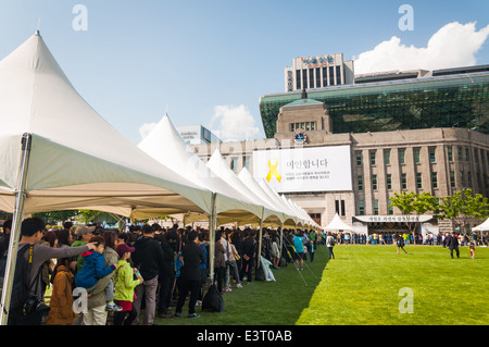 Mourners gather outside of Seoul City Hall on May 6, 2014 to pay their respects to victims of the Sewol ferry tragedy. Stock Photo