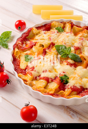 Cannoli stuffed with cheese and meat with red sauce.Selective focus on the cannoli pastry Stock Photo