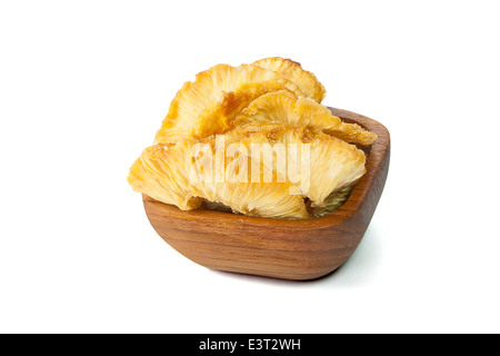 Bowl with dried pineapple isolated on white background Stock Photo