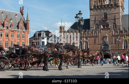 BRUGGE, BELGIUM - JUNE 12, 2014: The Carriage on the Grote Markt and Belfort van Brugge in background. Stock Photo