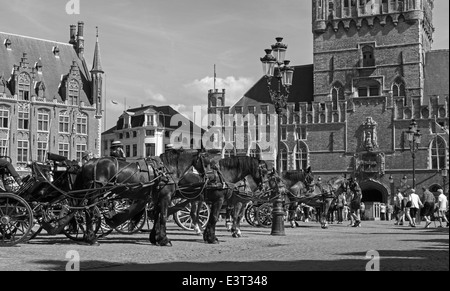 BRUGGE, BELGIUM - JUNE 12, 2014: The Carriage on the Grote Markt and Belfort van Brugge in background. Stock Photo