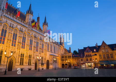 BRUGGE, BELGIUM - JUNE 12, 2014: The Burg square and facade of gothic town hall. Stock Photo