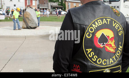 Le Claire, IOWA, USA. 28th June, 2014. The Scott County Freedom Rock arrived in LeClaire, Iowa on Saturday, June 28, 2014. The original Freedom Rock is a large (approx. 60  ton) boulder located in rural Iowa that is repainted every year with a different Thank You for our nations Veterans to honor their service to our country. The artist, Ray ''Bubba'' Sorensen II, was inspired by the movie Saving Private Ryan, as well as, wanting to give Veterans a unique recognition on Memorial Day. With 99 counties in Iowa presently there are 17 completed Freedom Rocks in other Iowa counties and 51 more cou Stock Photo