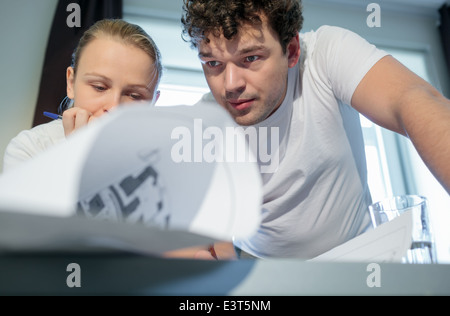 Two young architecs working with blueprints Stock Photo