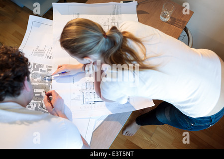 Young architects working with map and blueprint Stock Photo