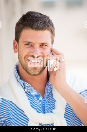 Young professional entrepreneur talking on cell phone. Confident, happy, and successful. Stock Photo