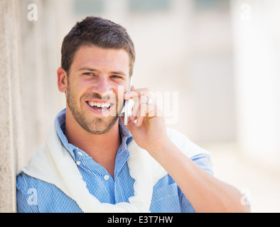 Young professional entrepreneur talking on cell phone. Confident, happy, and successful. Stock Photo