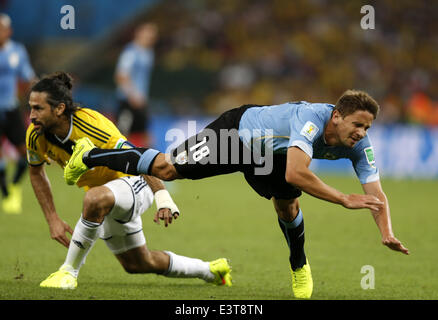 Rio De Janeiro, Brazil. 28th June, 2014. Uruguay's Gaston Ramirez (R) falls down during a Round of 16 match between Colombia and Uruguay of 2014 FIFA World Cup at the Estadio do Maracana Stadium in Rio de Janeiro, Brazil, on June 28, 2014. Colombia won 2-0 over Uruguay and qualified for Quarter-finals on Saturday. Credit:  Wang Lili/Xinhua/Alamy Live News Stock Photo