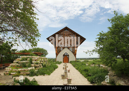 Gretna, NEBRASKA, USA. 3rd June, 2014. The Holy Family Shrine, 23132 Pflug Road, Gretna, NE was opened in 2002. Designed by BCDM Architects of Omaha, Nebraska. The unique church in the bluffs over looking the Platte Valley is visible from both directions on Interstate 80. The shrine is glass-walled, with supports holding up its 45-ft. tall roof. A man-made stream bubbles along a path cut along the walkway to the entrance and then in the floor of the nave. © Kevin E. Schmidt/ZUMAPRESS.com/Alamy Live News Stock Photo