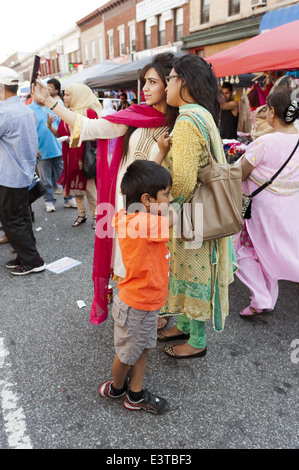 Woman takes a selfie at street fair in 'Little Bangladesh' in the Kensington section of Brooklyn, NY, 2014. Stock Photo