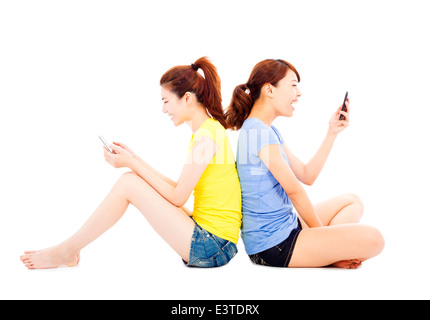 two happy pretty girls playing smart phone Stock Photo