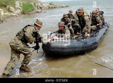 US Marines and Romanian sailors conduct beach reconnaissance during joint training exercises June 18, 2014 in Romania. Stock Photo