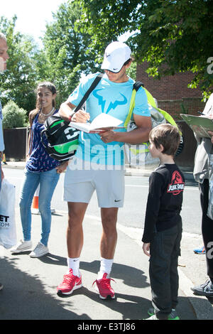 Wimbledon London, UK. 29th June 2014.  Rafael Nadal signs for a young autograph hunter as arrives  for tennis practice on middle sunday at the All England Club Credit:  amer ghazzal/Alamy Live News Stock Photo
