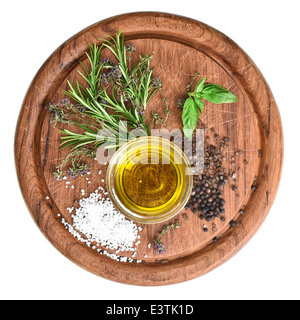 olive oil with fresh herbs thyme, basil and rosemary on wooden kitchen board Stock Photo