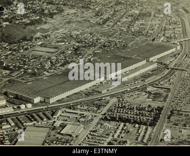 This aerial photograph shows the Consolidated/Convair aircraft factory in San Diego, with Lindbergh Field in the background. The factory was instrumental in the production of military aircraft during World War II and played a significant role in the development of civilian and military aircraft technologies in the post-war era. Stock Photo