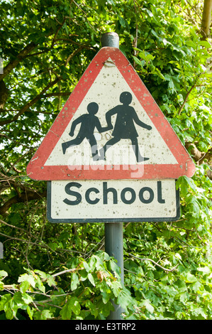 Traffic sign for school children crossing painted on a road pavement ...