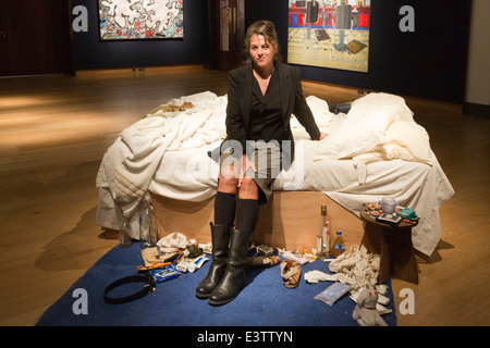 Tracey Emin poses with her famous artwork 'My Bed' (1998) at Christie's, London, prior to an auction. Stock Photo
