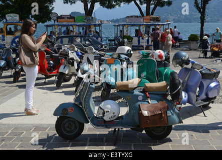 Vintage Italian Vespa scooter at scooters rally in Italy. 1964 Vespa 150 in foreground Stock Photo