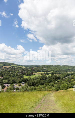 View over Surrey countryside and path from the popular recreational area, Box Hill near Dorking, UK in summer with blue sky Stock Photo