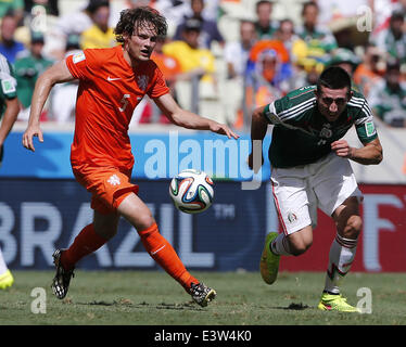 Fortaleza, Brazil. 29th June, 2014. Mexico's Hector Herrera vies with Netherlands's Daley Blind during a Round of 16 match between Netherlands and Mexico of 2014 FIFA World Cup at the Estadio Castelao Stadium in Fortaleza, Brazil, on June 29, 2014. Credit:  Zhou Lei/Xinhua/Alamy Live News Stock Photo