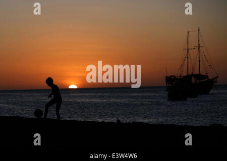 Fortaleza, Brazil. 29th June, 2014. A boy plays football on a beach in Fortaleza, Brazil, June 29, 2014. © Mauricio Valenzuela/Xinhua/Alamy Live News Stock Photo