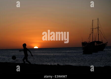 Fortaleza, Brazil. 29th June, 2014. A boy plays football on a beach in Fortaleza, Brazil, June 29, 2014. © Mauricio Valenzuela/Xinhua/Alamy Live News Stock Photo