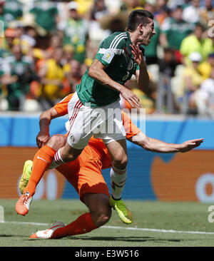 Fortaleza, Brazil. 29th June, 2014. Mexico's Hector Herrera vies with Netherlands's Ron Vlaar during a Round of 16 match between Netherlands and Mexico of 2014 FIFA World Cup at the Estadio Castelao Stadium in Fortaleza, Brazil, on June 29, 2014. Credit:  Zhou Lei/Xinhua/Alamy Live News Stock Photo