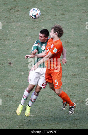 Fortaleza, Brazil. 29th June, 2014. Mexico's Hector Herrera (L) competes for a header with Netherlands' Daley Blind during a Round of 16 match between Netherlands and Mexico of 2014 FIFA World Cup at the Estadio Castelao Stadium in Fortaleza, Brazil, on June 29, 2014. Netherlands won 2-1 over Mexico and qualified for Quarter-finals on Sunday. Credit:  Liao Yujie/Xinhua/Alamy Live News Stock Photo