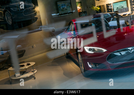 A Tesla Model S electric car is seen through the window of the downtown Washington, D.C., Tesla car dealership Stock Photo