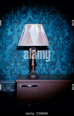 Retro lamp on blue rococo background. Vintage pattern. Vintage lamp. Vignette. Rich rustic interior Stock Photo