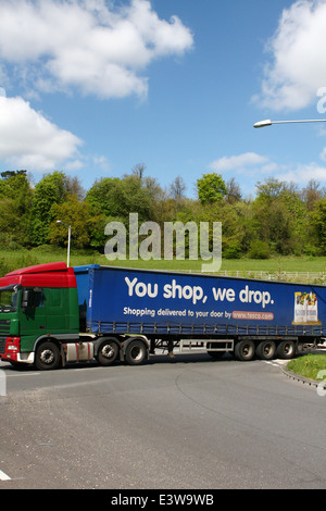 A Tesco truck entering a roundabout in Coulsdon, Surrey, England Stock Photo