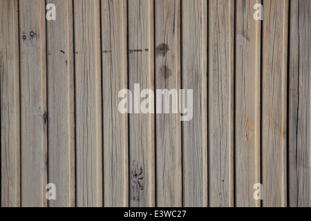 horizontal picture of old grey vertical planks with peeling beige and brown paint Stock Photo