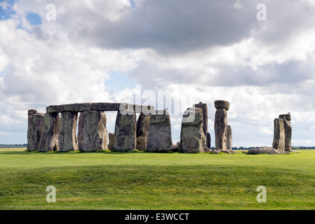 White fluffy clouds floating in a blue sky over the iconic UNESCO World Heritage Site at Stonehenge, Wiltshire, UK.